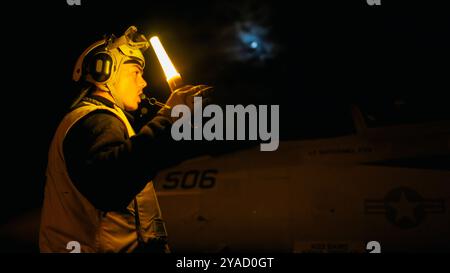 Aviation Boatswain’s Mate (Aircraft Handling) 3rd Class Reo Lewis aus Denver steuert ein Flugzeug auf dem Flugdeck der Nimitz-Klasse carrie Stockfoto