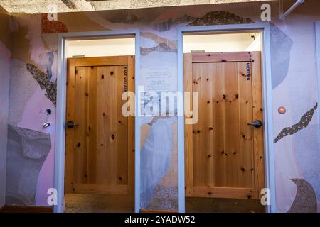 Levi's Boutique-Ankleideräume mit Holztüren mit der Bezeichnung East Village und Midtown, die moderne Designelemente präsentieren. New York. USA. Stockfoto