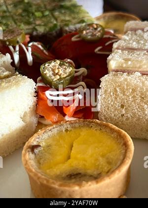 Eine Auswahl an herzhaften Häppchen, darunter geräucherter Lachs, Quiche und Schinken-Sandwiches, serviert während des High Tea im Empress Hotel Stockfoto