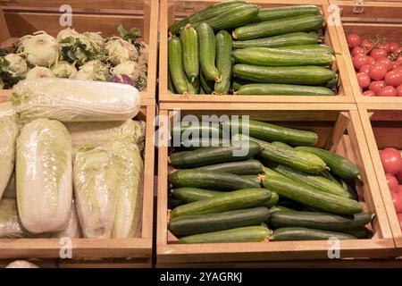 Ein vielfältiges Sortiment an frischem Gemüse ist wunderschön in Holzkisten angeordnet und zeigt ihre lebendigen Farben und Texturen Stockfoto