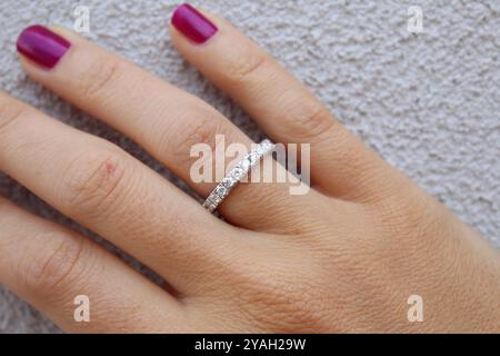 Diamant-Ring auf einer schönen Hand und einem Wandhintergrund Stockfoto