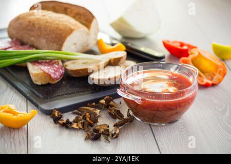 Fastenborsch mit getrockneten Pilzen und Gemüse auf einem hellen Holztisch. Stockfoto