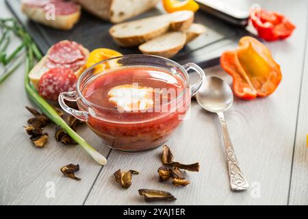 Fastenborsch mit getrockneten Pilzen und Gemüse auf einem hellen Holztisch. Stockfoto