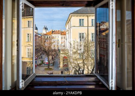 Lviv, Ukraine - 21. Januar 2020: Fensterblick auf den historischen Marktplatz der ukrainischen Altstadt mit Geschäften und Menschen, die am Weihnachtsmarkt vorbeilaufen Stockfoto