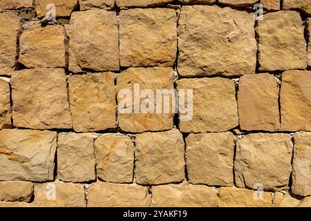 Großer Sandsteinblock gemusterte Backsteinmauer Nahaufnahme Hintergrund und Textur Stockfoto