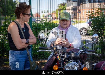 The Distinguished Gentleman's Ride (DGR) 2024. Dame auf Motorradkombination mit ihrem Jack Russell Stockfoto