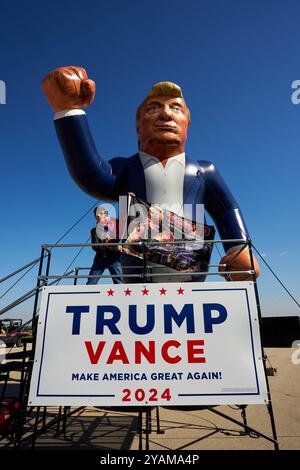 Juneau, Wisconsin, USA. Oktober 2024. Ein Teilnehmer posiert mit einem aufblasbaren DONALD TRUMP vor einer Kundgebung des ehemaligen Präsidenten am Dodge County Airport in Juneau, Wiss. Am Sonntag, den 6. Oktober. TRUMP sagte, wenn er die Wahl verliert, ist dieses Land am Ende. (Kreditbild: © Jeff M. Brown/ZUMA Press Wire) NUR REDAKTIONELLE VERWENDUNG! Nicht für kommerzielle ZWECKE! Stockfoto