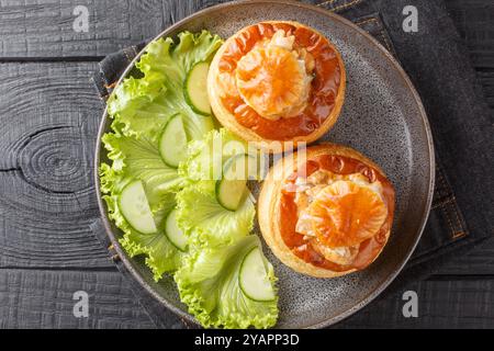 Köstlicher klassischer Bouchee vol-au-Vent gefüllt mit Rindereintopf in einem Teller auf einem Holztisch. Horizontale Draufsicht von oben Stockfoto