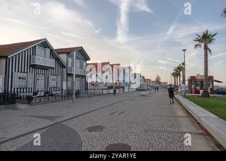 Costa Nova do Prado, Aveiro, Portugal - 30. August 2024 - portugiesische Touristenstraße mit ihren emblematischen gestreiften und bunten Häusern. Ende des Tages. Stockfoto