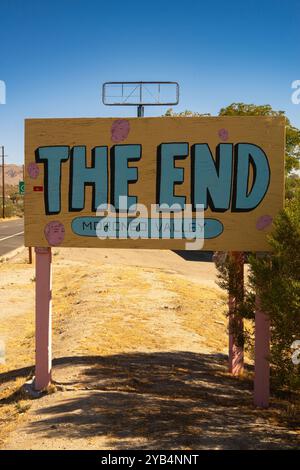 Eine seltsame Szene mit dem Endschild vor einem großen leeren Schild in Morongo Valley, Kalifornien. Stockfoto