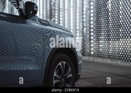 Blaue Suzuki Vitara bei Nacht. Kotflügelansicht der japanischen SUV-Überkreuzung – wenn und glänzende Karosserie. Stockfoto