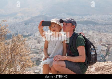 Glücklicher Familienvater und Tochter machen Selfie gegen Athen, Griechenland Stockfoto