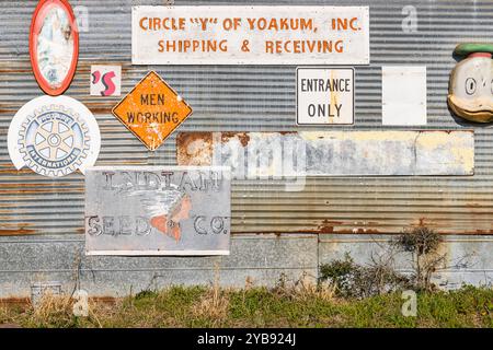 Yoakum, Texas, Usa. März 2022. Antike Schilder an einem Wellblechgebäude. Stockfoto