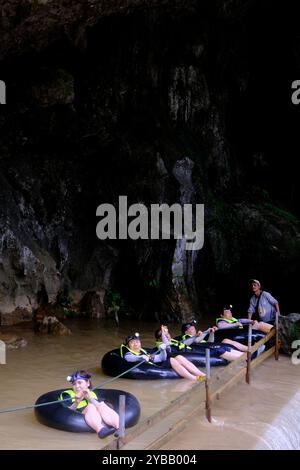 Touristen folgen einem Seilschlauch in die Tham Nam Wasserhöhle. Vang Vieng, Laos Stockfoto