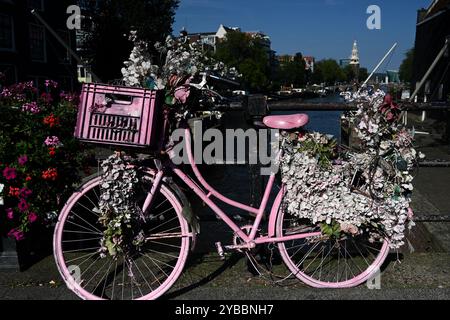 Ein Fahrrad auf dem Parkplatz am Ufer des Kanals in Amsterdam, Niederlande Stockfoto