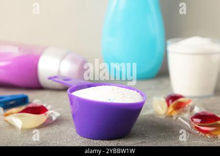 Waschmittel mit Waschpulver und Kapseln auf grauem Hintergrund. Draufsicht Stockfoto