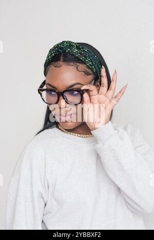 afroamerikanerin, die ihre Brille hält Stockfoto