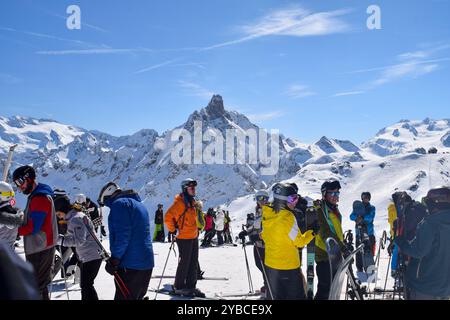 Meribel, Frankreich - 13. März 2024: Top der Skigebiete Meribel und Courchevel, drei Täler. Skifahrer und Snowboarder auf dem Gipfel des Saulire Berges. Stockfoto