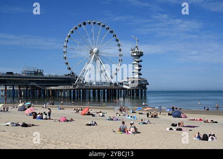 The Haag, Niederlande - 28. August 2024: Die Menschen entspannen sich am Strand in der Nähe des Pier SkyView in den Haag. Stockfoto