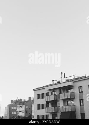 Moderne Urban Apartment-Gebäude vor klarem Himmel in Schwarz und weiß Stockfoto