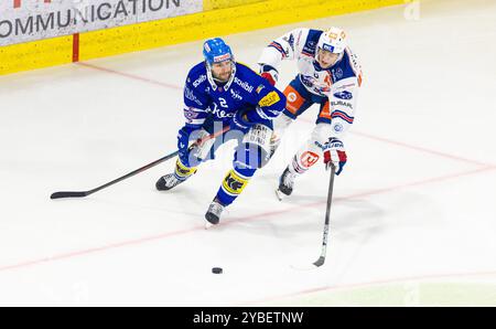 Kloten, Schweiz, 18. Oktober 2024: Verteidiger #2 Thomas Gregoire (Kloten) spielt den Pass, bevor #9 Vicenz Roher (ZSC Lions) ihn stören kann. (Foto: Andreas Haas/dieBildmanufaktur) Credit: DieBildmanufaktur/Alamy Live News Stockfoto