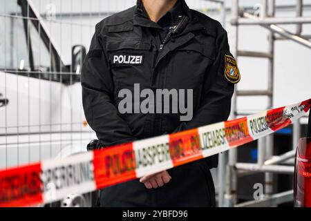 Augsburg, Bayern, Deutschland - 18. Oktober 2024: Ein Polizeibeamter steht hinter einer Polizeibarriere am Karriereinformationstag des Polizeipräsidiums Schwaben Nord in Augsburg *** ein Polizeibeamter steht hinter einer Polizeiabsperrung am Berufsinformationstag vom Polizeipräsidium Schwaben Nord in Augsburg Stockfoto