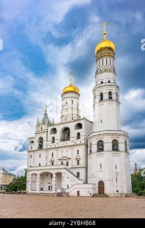 Der große Glockenturm Ivan, mit dem Himmelspatel auf der rechten Seite an einem sonnigen Tag mit blauem Himmel. Blauer Himmel Hintergrund mit Sonnenstrahlen. Moskauer Kreml, Russland Stockfoto