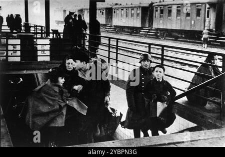 Eine jüdische Familie klettert während einer Deportation aus dem Krakauer Ghetto die Treppe zum Bahnsteig am Bahnhof. Das Krakauer Ghetto wurde 1942/43 liquidiert und fast alle Einwohner wurden nach Belzec und Auschwitz geschickt. Einige der fähigen Menschen wurden in Sklavenarbeitslager geschickt. Stockfoto