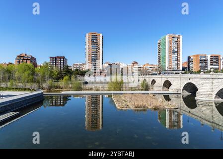 Madrid, Spanien, 14. März 2021: Madrid Rio. Brücke von Segovia und Puerta del Angel. Reflexionen von Wohntürmen auf dem Wasser, Europa Stockfoto