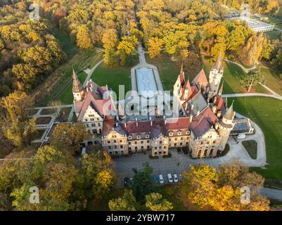 Aufnahmen der Luftdrohne vom Schloss Moszna, Polen atemberaubende Ausblicke auf die majestätische neogotische und barocke Architektur, umgeben von üppigen Gärten und landschaftlich reizvollen Landschaften Stockfoto