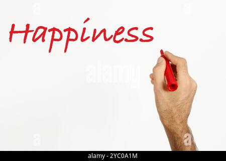 Ein Mann schreibt "Glück" auf weißes Tafel mit rotem Marker. Leerzeichen für Text. Stockfoto