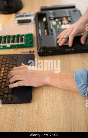 Männliche Ingenieurhände reparieren Laptop-Computer Stockfoto