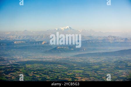 Erfassen Sie die majestätischen Alpen von einem Flugzeug aus mit schneebedeckten Gipfeln und der weitläufigen Landschaft unter einem klaren blauen Himmel Stockfoto