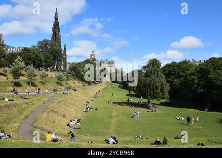 Menschen genießen die Sonne in den East Princes Street Gardens im Stadtzentrum von Edinburgh, Schottland. Stockfoto