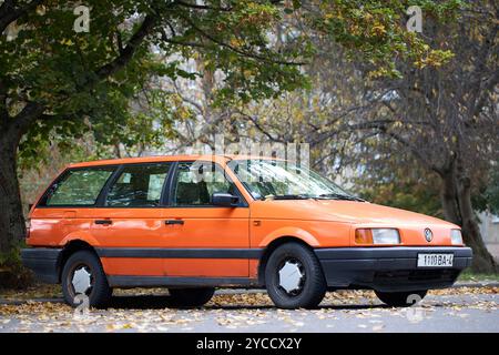 Minsk, Weißrussland - 22. Oktober 2024: Volkswagen Passat B3 GT OLrange Metallic Universal Selective Focus Side Dreiviertelansicht im Freien im Herbst Urban Stockfoto