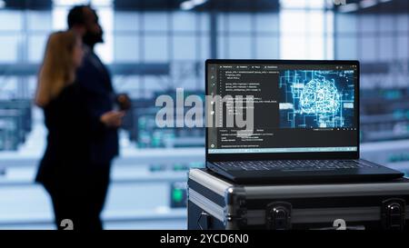 Laptop in Rechenzentren mit künstlicher Intelligenz, die menschliches Gehirn simuliert, handgeführte Kameraaufnahme. Nahaufnahme eines Geräts, das KI-Algorithmen für maschinelles Lernen im Server-Hub, Kamera A, anzeigt Stockfoto