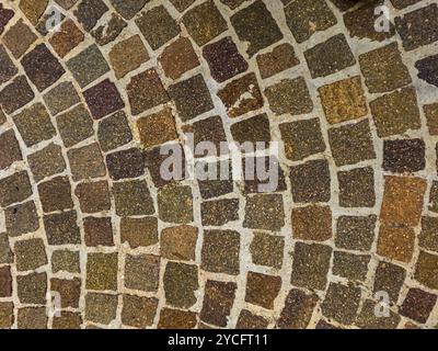 Alte Kopfsteinpflasterpflaster abstrakte Hintergrundoberfläche oben Nahansicht Stockfoto