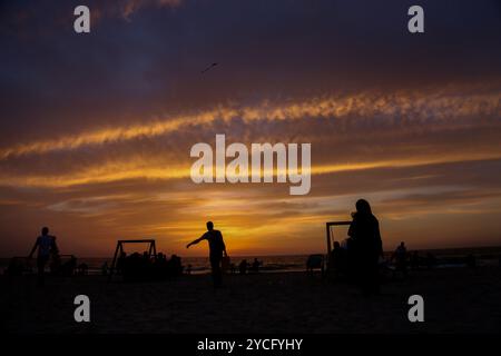 Gaza, Palästina. 16. Mai 2020. Palästinenser genießen den Sonnenuntergang am Meer in Gaza-Stadt. Palästinensern ist es gestattet, während des Ramadan bei Familienversammlungen am Strand ihr iftar- oder Abendmahl zu konsumieren, obwohl im Gazastreifen einige Vorsichtsmaßnahmen getroffen wurden, um die Ausbreitung von COVID-19 zu verhindern. Ausflüge und Picknicks an die Küste und ihre fröhliche Atmosphäre bieten den Gazastreibern eine gewisse Erleichterung von ihren Sorgen über die hohe Armutsrate und Arbeitslosigkeit sowie die häufigen Stromausfälle in der belagerten palästinensischen Enklave Stockfoto