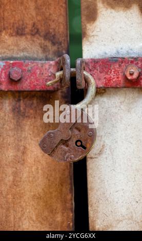 Rostige Vorhängeschloss an einem alten Metalltür Stockfoto