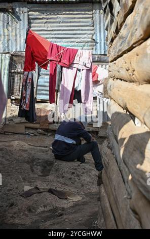 KIBERA SLUM IN NAIROBI, KENIA - 18. NOVEMBER 2022: Enge Straßen mit Trockenwäsche im Kibera Slum von Nairobi. Kenia, Afrika Stockfoto