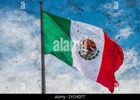 Grunge-Bild der mexikanischen Flagge über blauem bewölktem Himmel Stockfoto
