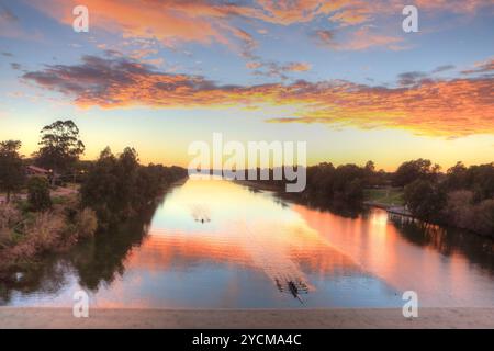 Wunderschöner Sonnenaufgang über dem Nepean River, Penrith NSW, Australien. Kajakfahrer üben am frühen Morgen, bevor größere Wasserfahrzeuge das Wasser aufwirbeln Stockfoto