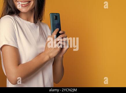 Frau versteckt Telefon, zugeschnittene Ansicht. Frau mit Smartphone. Chatten und SMS schreiben. Online verbunden. Private Nachricht. SMS-Kommunikation. Mädchen chatten Stockfoto