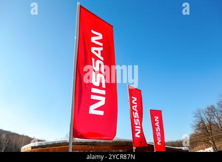 SAMARA, Russland - 14. Februar 2016: Autohaus Fahnen Nissan über blauen Himmel im sonnigen Tag. Nissan ist ein japanischer multinationalen Automobilunternehmen Stockfoto