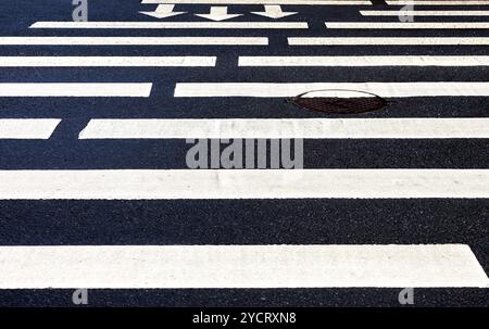 Zebrastreifen mit weiße Markierung Linien und Bewegungsrichtung auf asphalt Stockfoto