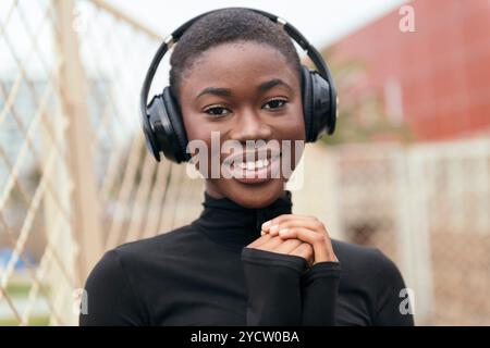 Schwarze Frau, die Musik über Kopfhörer hört Stockfoto