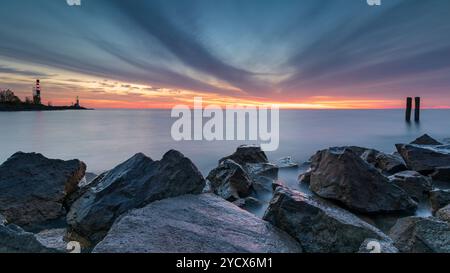 Während der blauen Stunde an diesem wunderschönen Morgen entfaltet sich ein spektakuläres Farbenspiel über dem IJsselmeer. Die aufgehende Sonne malt die Wolken im Stockfoto