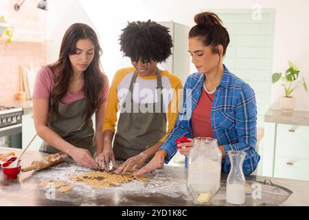 weihnachtskekse backen, multirassische Freundinnen, zu Hause Stockfoto