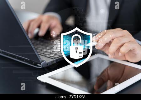 Datenschutzkonzept für Cybersicherheit. Professioneller Benutzer, der einen Laptop mit virtuellem Schutzschild verwendet, der Online-Datensicherheit und Cyberschutz darstellt Stockfoto