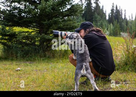 Fotograf, der ein Foto mit seinem Hund in der Nähe macht Stockfoto